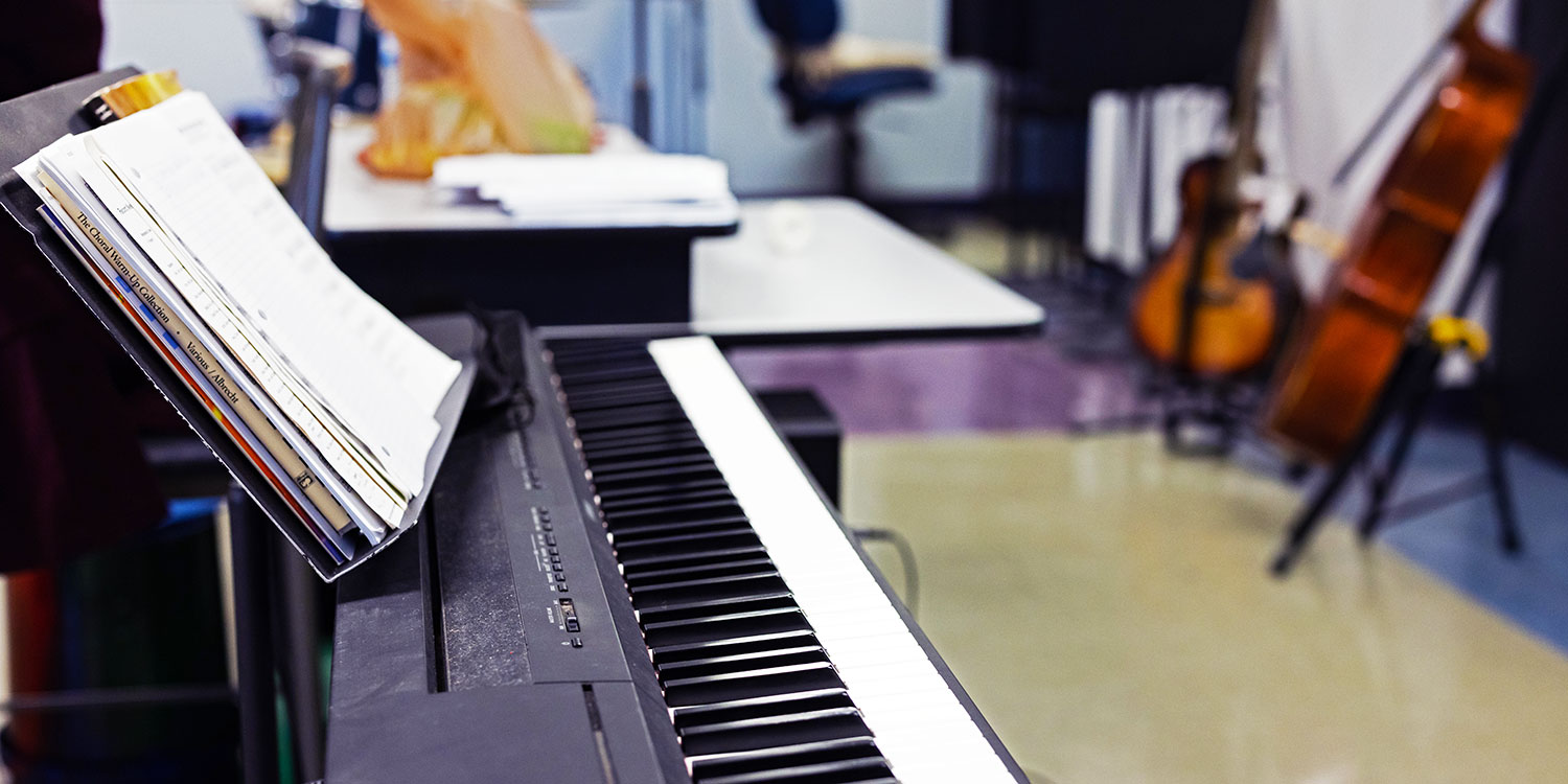 A close-up of a piano in a music classroom.